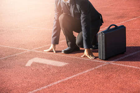 A businessman on a track ready for race in businessの写真素材