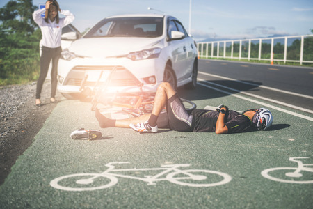 Asia cyclist injured on the street bike after collision accident car and bike.の写真素材