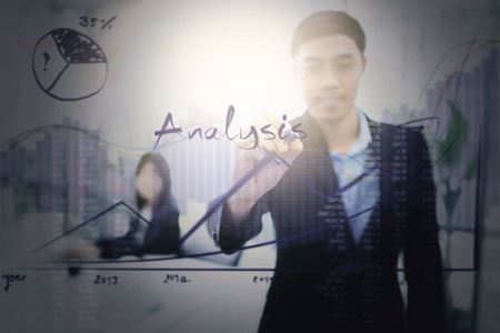 Businessman writing financial analysis graph with key performance indicators.Visualization of marketing positioning and similar situations on market. analysis concept.の写真素材