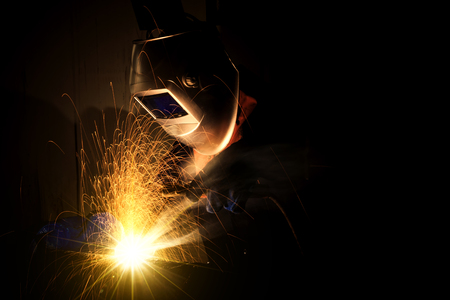 Industrial Worker at the factory welding closeup, welder Industrial automotive part in factory, selective focusの写真素材