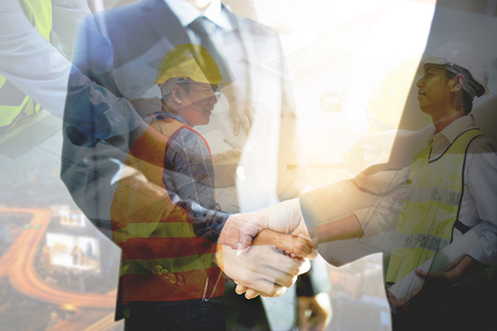 Double exposure of handshake and city, Double exposure of handshake and Business People working.の写真素材