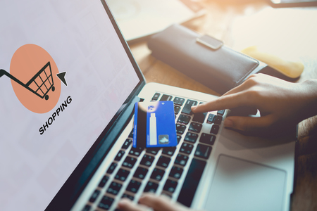 Hands holding credit card and using laptop. Online shopping, technology and internet concept.の写真素材