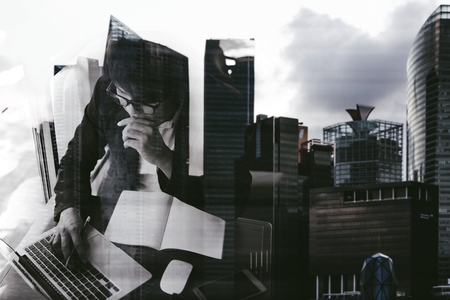 Double exposure of a businessman working and cityscape on whit background.のeditorial素材