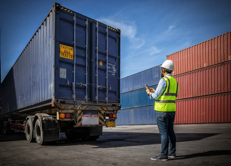 Foreman control loading Containers box to truck for Logistic Import Export Background, Business...