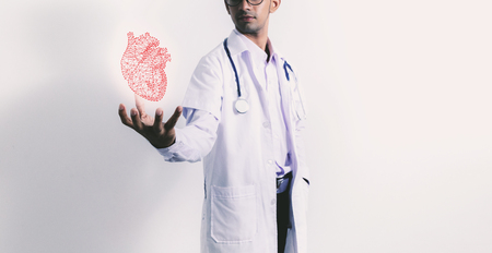 Doctor holding virtual heart on the white background.の写真素材