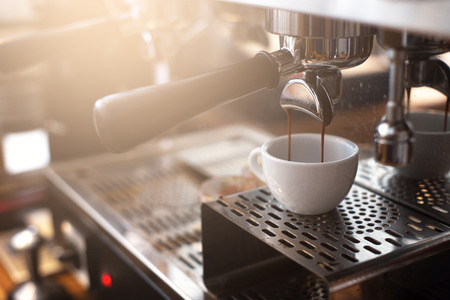 Espresso extraction from coffee machine in coffee shop.の写真素材