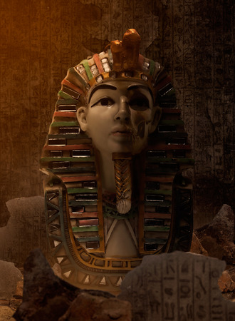 Egypt pharaoh bust standing in ancient ruins cave with egyptian symbols wall.の写真素材