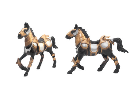 Isolated battle horse toy in golden & steel armor outfit angle & profile view.