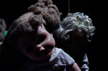 Scary hanged horror dark dolls on black background composition.の写真素材