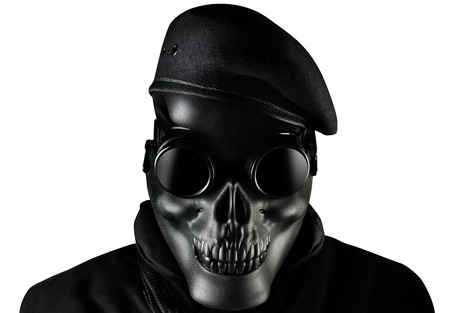 Photo of a fully equipped soldier in black armor vest standing in skull mask, glasses and beret isolated on white background closeup front view.の写真素材
