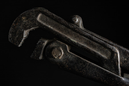 Photo of an old adjustable wrench close up photo on black background.の写真素材