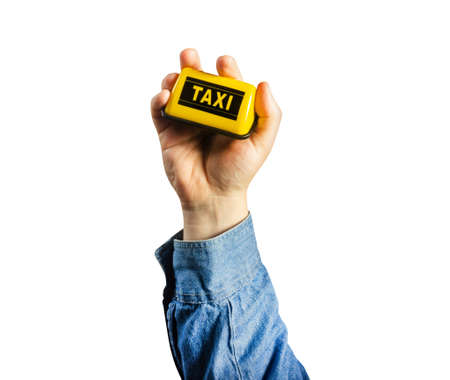 Photo of isolated male hand in shirt holding taxi sign.の写真素材