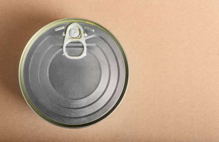 canned food upper view on cardboard background.