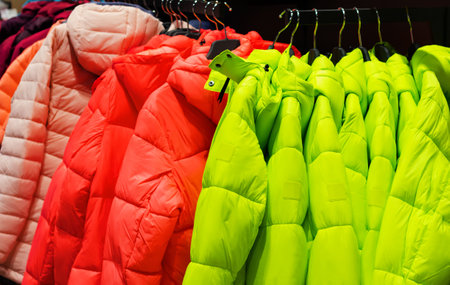 fashion store rack with various colored winter jackets.の写真素材