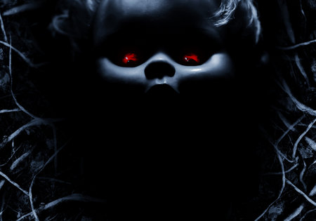 Creepy horror photo of old fashioned doll face with red eyes backdrop photo with dark roots copyspace.の写真素材