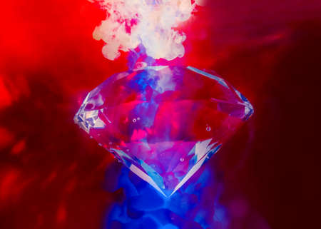 Photo of shining red toned diamond under water with air bubbles and color neon ink splashes.の写真素材