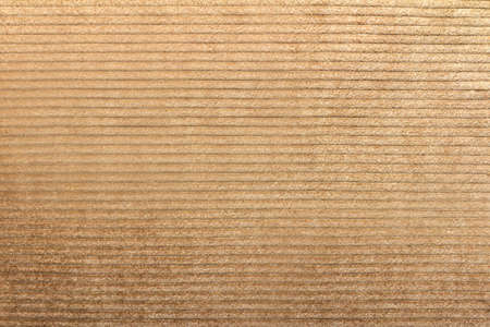 Texture backdrop photo of beige colored corduroy fabric cloth.