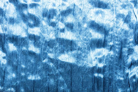 Texture backdrop photo of blue colored patterened satin cloth material.