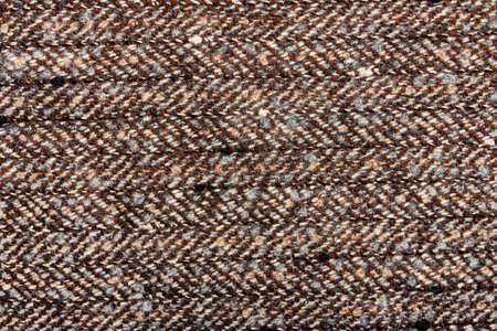 Texture backdrop photo of brown colored woold knitted fabric cloth.