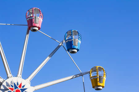Photo of ferris wheel booths on blue sky background.の写真素材