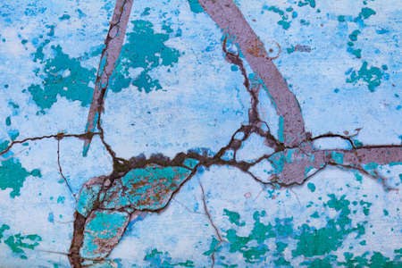 Photo texture of old and cracked blue colored concrete wall.の写真素材