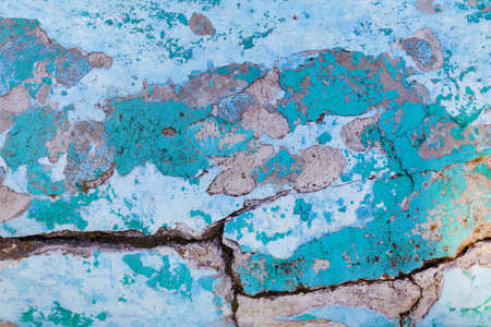 Photo texture of old and cracked blue colored concrete wall.の写真素材