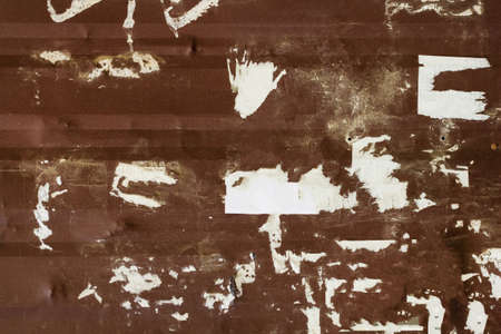 Photo texture of grunge metal rusty wall with torn paper.