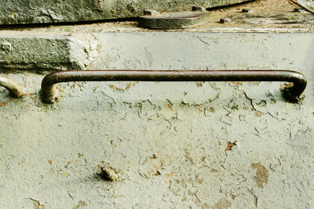 Photo of old and rusty green colored military vehicle armored surface with handle.の写真素材