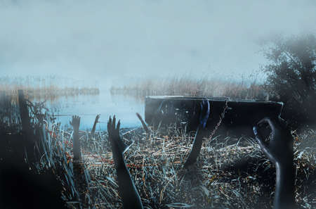 Photo of horror scary haunted foggy river shore with boat and ghost hands reaching out from ground.