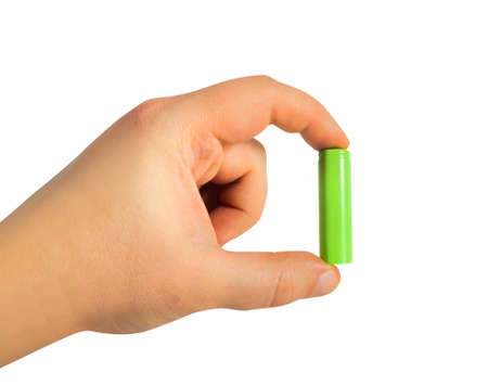 Isolated photo of male hand holding grenn colored rechargeable battery on white background.