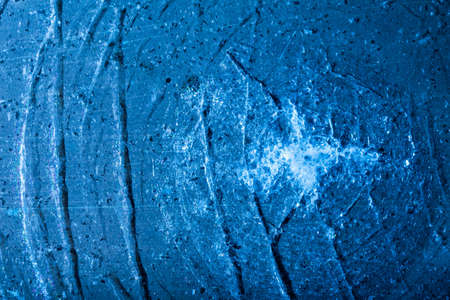 Photo of blue toned frozen cracked ice on metal surface texture.の写真素材