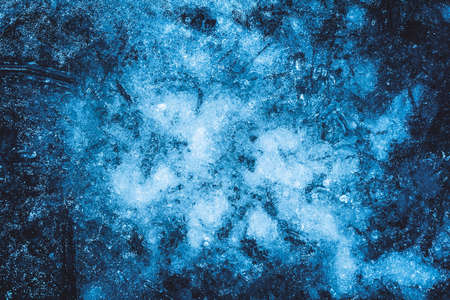Photo of blue toned frozen ground covered in ice texture.の写真素材