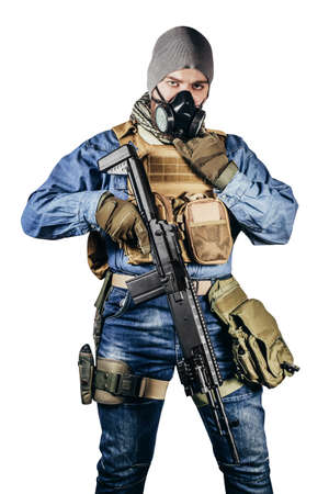 Isolated photo of urban soldier in tactical military outfit and gas mask standing with rifle and gas mask white background.の写真素材