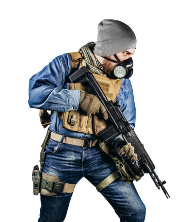 Isolated photo of urban soldier in tactical military outfit and gas mask standing with rifle and gas mask white background.の写真素材