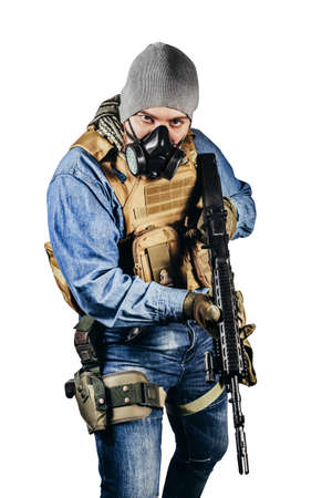 Isolated photo of urban soldier in tactical military outfit and gas mask standing with rifle and gas mask white background.の写真素材