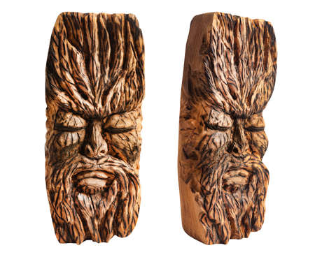 Isolated photo of fantasy face ancient pagan god totem idol carved in wood on white background.の写真素材
