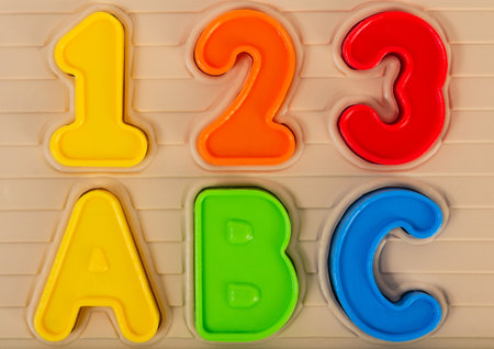 Close up photo of kids toy multi colored numbers and alphabet letters.の写真素材