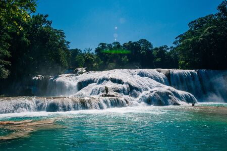 Agua Azul, Chiapas, Palenque, Mexico. View of the amazing waterfall with turquoise pool surrounded by green trees.の写真素材