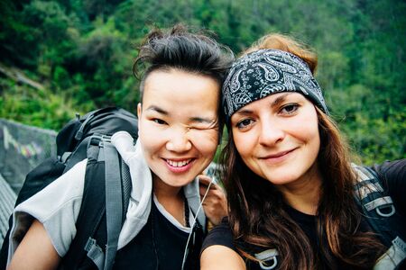 tourists are enjoying the selfie with friends.の写真素材