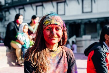 Portrait of happy young girl on holi color festival in Nepalの写真素材