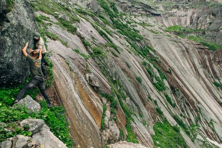 Tourist with a backpack and mountain panoramaの写真素材