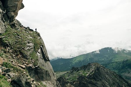 Silhouette of a champion on mountain peak. Active lifeの写真素材