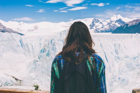 Tourist standing on footbridge in front of Perito Moreno Argentinaの写真素材