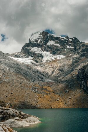 A landscape view of laguna churup, a lagoon hidden in the peruvian andes mountains near the town of huaraz, ancash.の写真素材