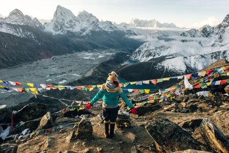 Female Tourist Hikking at gokyo ri mountain peak near gokyo lake during Everest base camp trekkingの写真素材