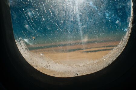 airplanes photographed through the porthole window, while flying above the clouds