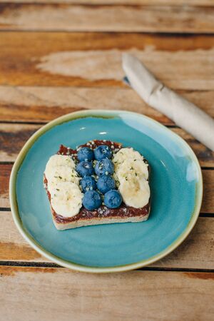 toast with chocolate paste, bananas and blueberriesの写真素材