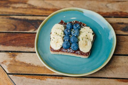 toast with chocolate paste, bananas and blueberriesの写真素材