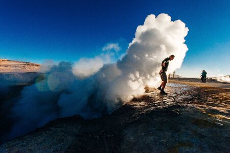 A man in the geysers at bolivian highlands Sol de la Manana, Uyuni Desert - december, 2018.のeditorial素材