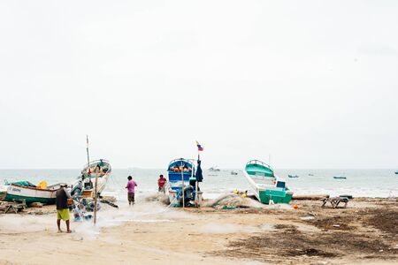 peru - november, 2018 - Fishermen and boats in a feather on the Pacific coastのeditorial素材